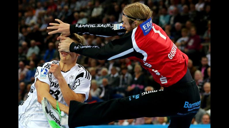 Bergischer goaltender Bjorgvin Gustavsson, right, collides with Kiel's Rune Dahme during a handball match in Kiel, Germany, on Wednesday, September 30.