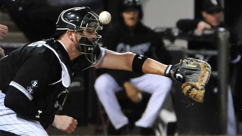 Tyler Flowers, catcher for the Chicago White Sox, takes a foul ball off his mask during a home game against Kansas City on Thursday, October 1.