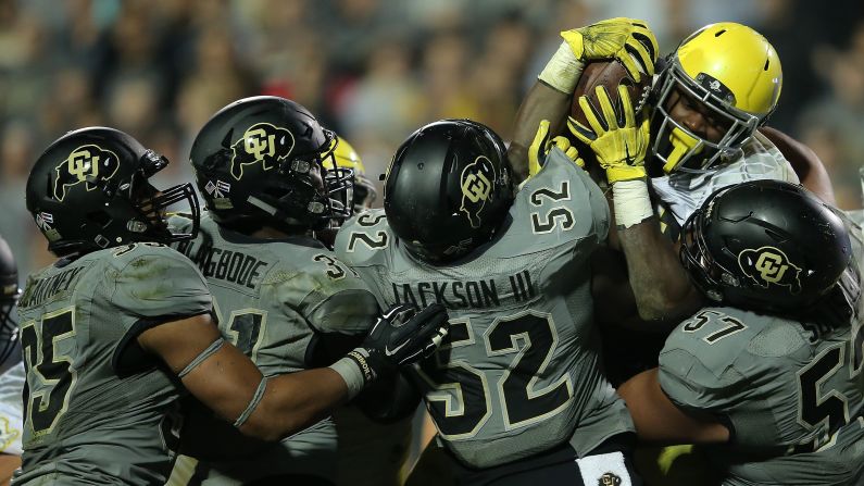 Oregon running back Royce Freeman is met by four Colorado defenders during a college football game in Boulder, Colorado, on Saturday, October 3. Oregon won 41-24. Freeman had 163 rushing yards and two touchdowns.