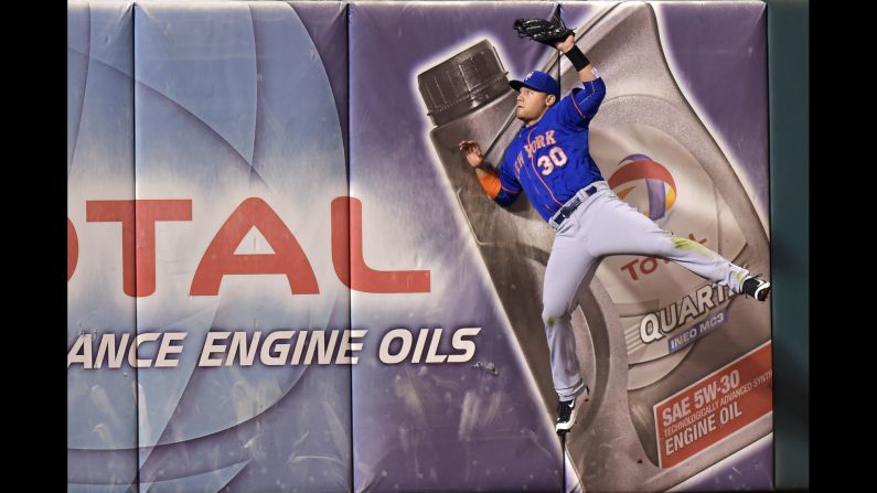 Michael Conforto, a rookie for the New York Mets, catches a fly ball as he hits the outfield wall in Philadelphia on Wednesday, September 30.