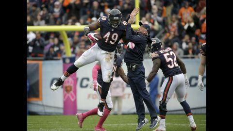Chicago Bears head coach John Fox celebrates a fumble recovery with defensive end Sam Acho on Sunday, October 4.