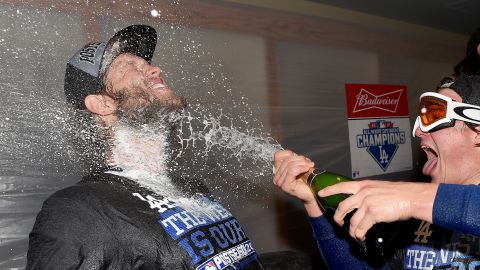 Clayton Kershaw, ace pitcher for the Los Angeles Dodgers, is sprayed with champagne after the Dodgers beat San Francisco to clinch the division title on Tuesday, September 29.