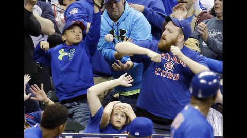 Fans try to catch a foul ball during a Major League Baseball game in Milwaukee on Friday, October 2.