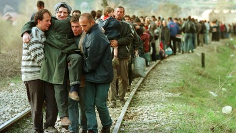 Ethnic Albanian refugees arrive by foot in Macedonia in April 1999 after being forced to leave a train coming from Pristina in Kosovo.
