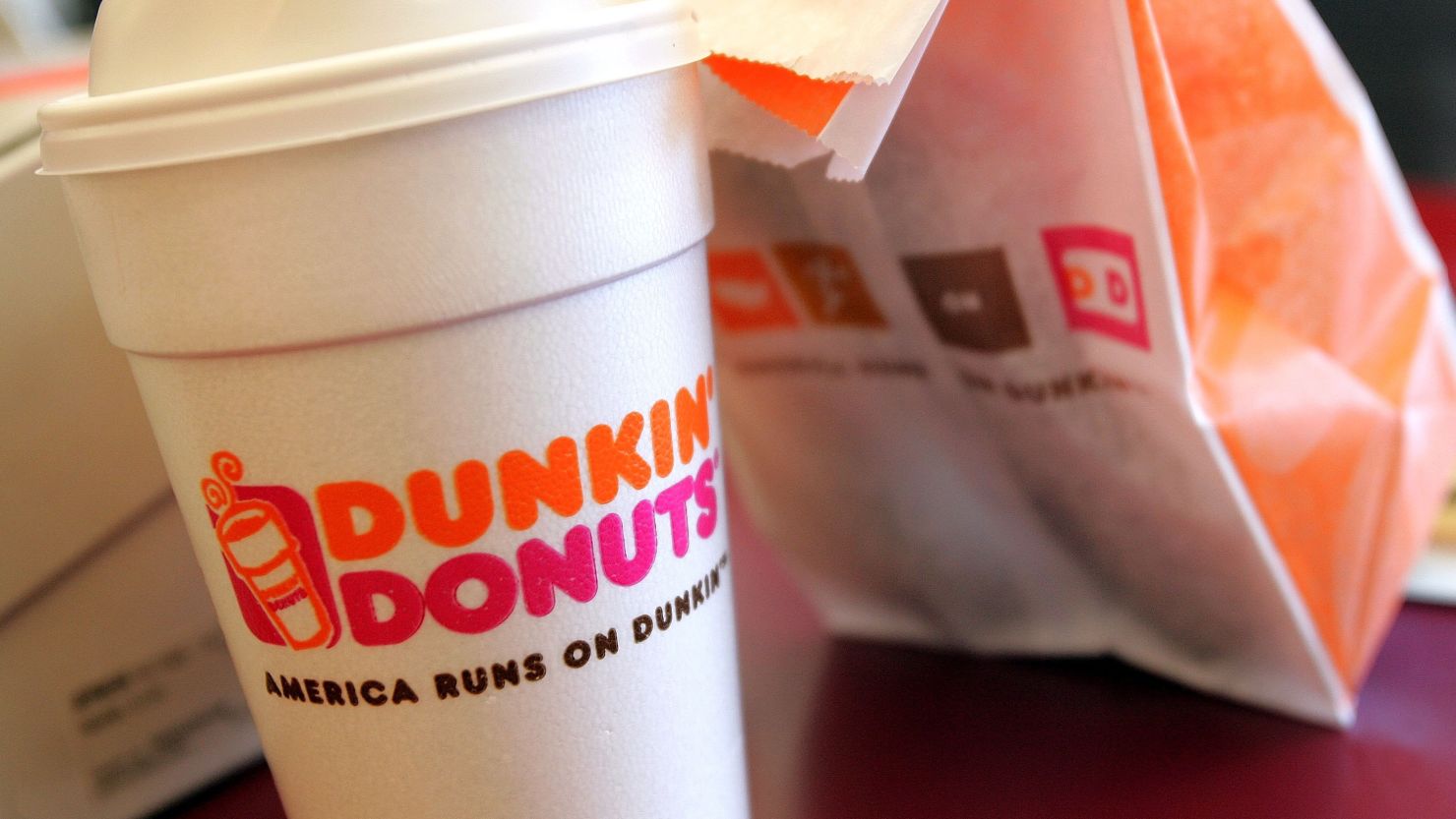 Dunkin' Donuts says it will work with store owners and employees after complaints from police officers.