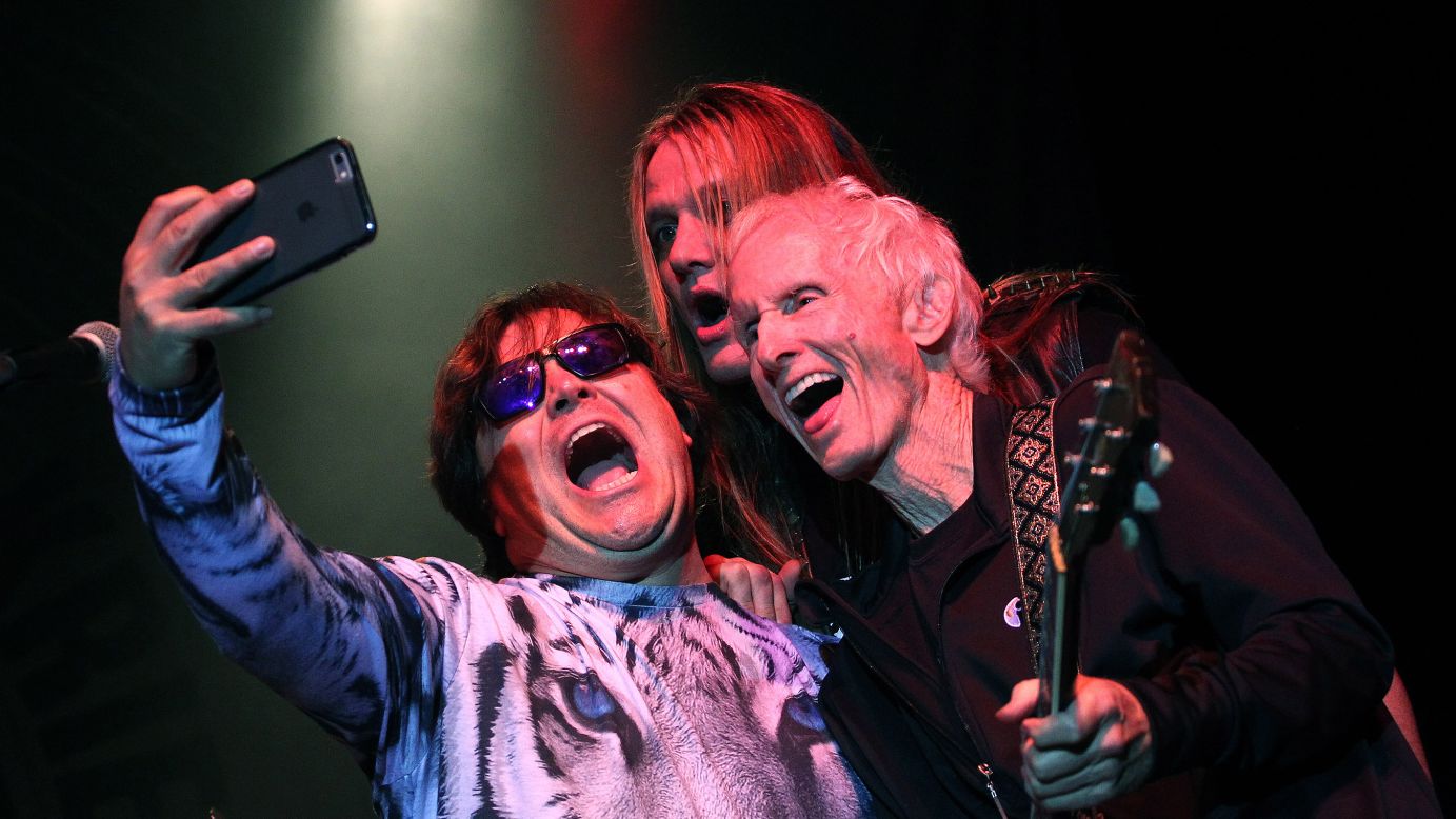From left, musicians Jack Black, Sebastian Bach and Robby Krieger take a photo on stage during a concert in Moorpark, California, on Monday, October 5.