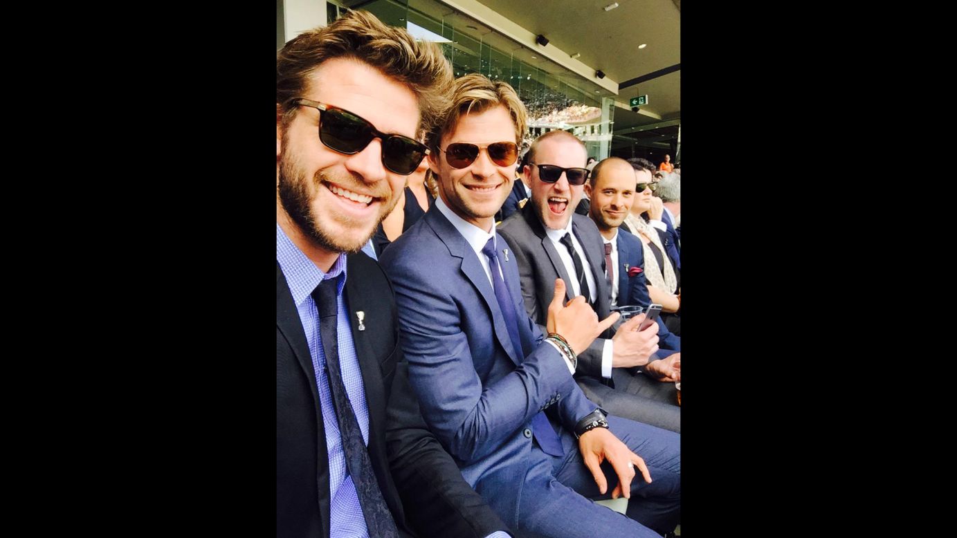 Actor Liam Hemsworth, left, <a href="https://twitter.com/LiamHemsworth/status/650182791255228416" target="_blank" target="_blank">tweeted this selfie</a> from the Australian Football League's grand final on Saturday, October 3. "At ‪#AFLGrandFinal with the boys!" he said. "‪#GoTheHawks!"
