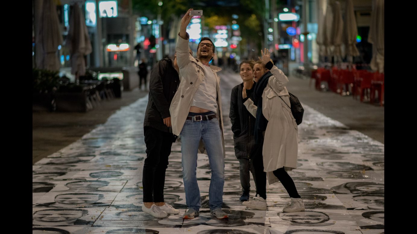 People in Vienna, Austria, take a selfie as they stand on portraits of migrants on Friday, October 2. The portraits were part of an art project raising awareness about <a href="http://www.cnn.com/specials/world/migration-crisis" target="_blank">the migration crisis</a> in Europe. <a href="http://www.cnn.com/2015/09/30/living/gallery/look-at-me-selfies-0930/index.html" target="_blank">See 33 selfies from last week</a>