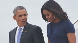 US President Barack Obama and First Lady Michelle Obama step off Air Force One upon arrival at Andrews Air Force Base in Maryland on September 29, 2015.