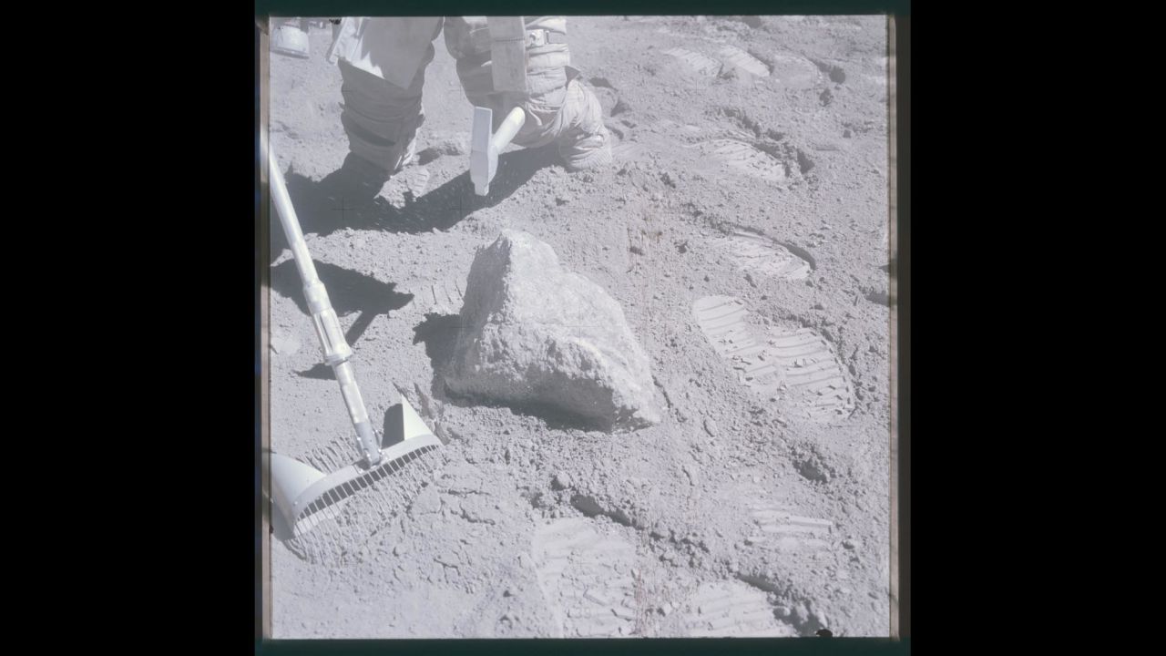 Astronaut Charlie Duke tries to break a sample loose during Apollo 16.