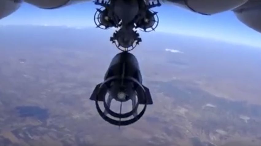 In this photo made from the footage taken from Russian Defense Ministry official web site on Monday, Oct. 5, 2015 a bomb is released from Russian Su-24M jet fighter  in Syria. NATO strongly criticized the Russian air campaign in Syria that began Wednesday. (Russian Defense Ministry Press Service via AP)