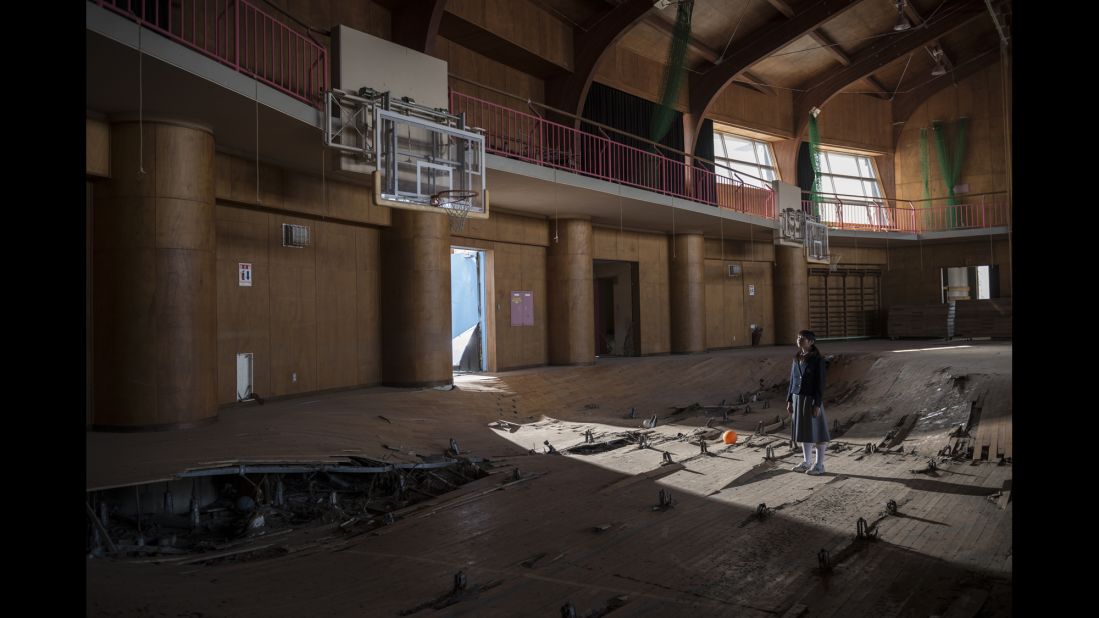 Kanoko Sato stands in a destroyed gym in Ukedo.