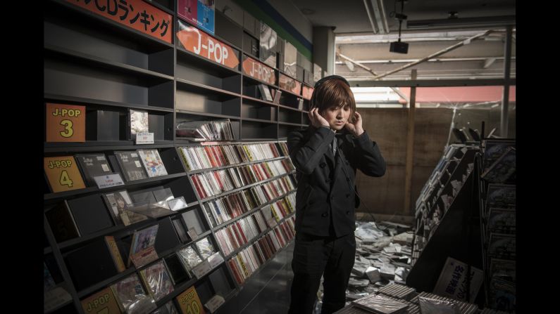 Noboru Eda stands in an abandoned music store in Namie.