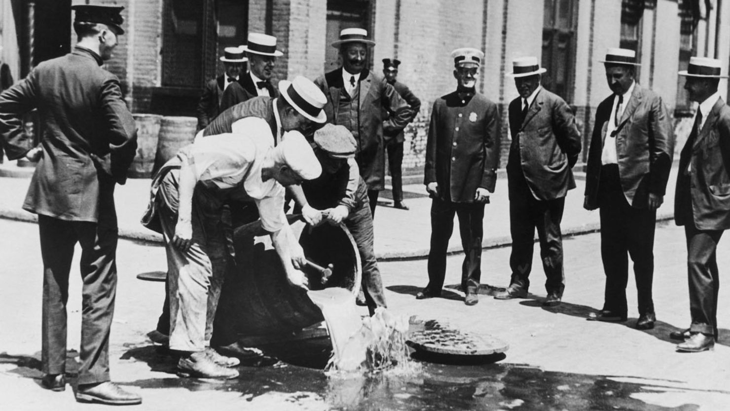 Alcohol is poured away into a New York sewer during the prohibition era, circa 1920. 