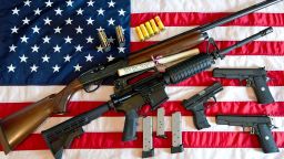 This February 4, 2013 photo illustration in Manassas, Virginia, shows a Remington 20-gauge semi-automatic shotgun, a Colt AR-15 semi-automatic rifle, a Colt .45 semi-auto handgun, a Walther PK380 semi-auto handgun and various ammunition clips with a copy of the US Constitution on top of the American flag. US President Barack Obama Monday heaped pressure on Congress for action "soon" on curbing gun violence. Obama made a pragmatic case for legislation on the contentious issue, arguing that just because political leaders could not save every life, they should at least try to save some victims of rampant gun crime. AFP PHOTO/Karen BLEIER        (Photo credit should read KAREN BLEIER/AFP/Getty Images)