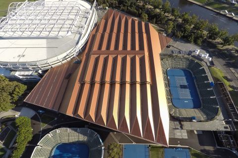 Architects from NH Architecture observe that the dominant aesthetic of sports facilities are usually composed of steel trusses and generic concourses. The firm opted to create an arena that shifted away from the over industrial scale of stadium architecture. The pleated copper-penny roof is a standout feature. 