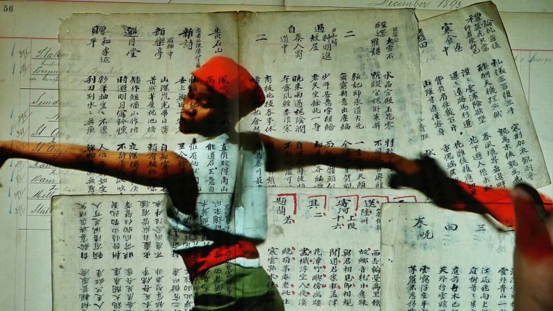 South African dancer Dada Massilo, a frequent collaborator with Kentridge, is seen in Chinese military uniform, dancing across torn maps, notebooks, and documents. 