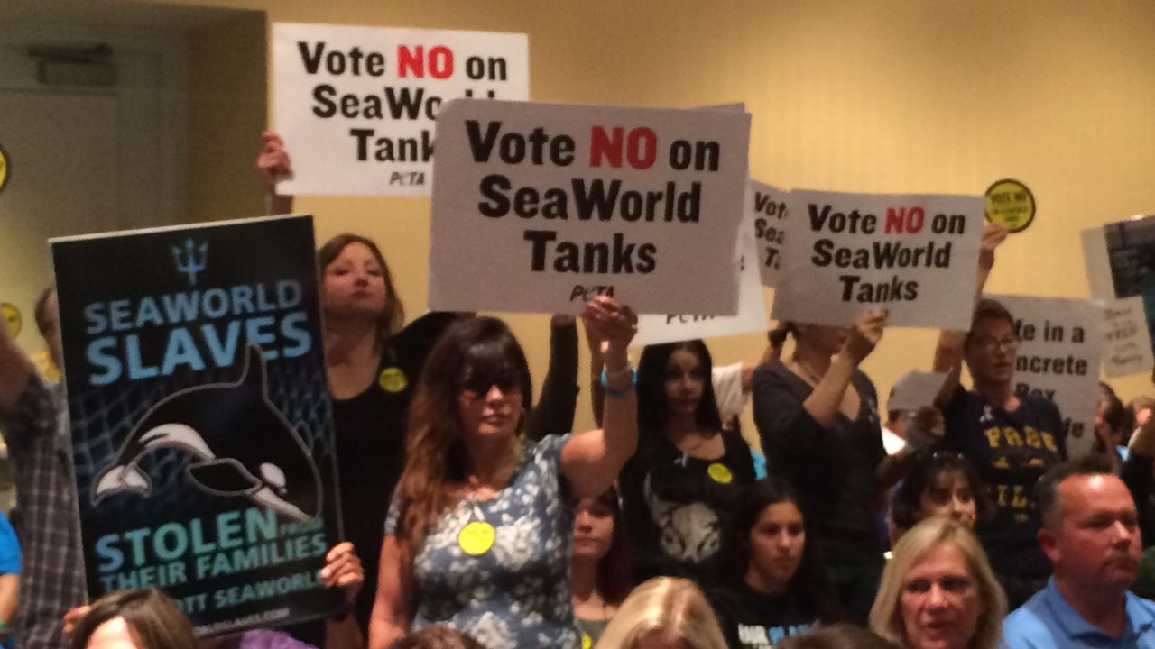 Opponents carried signs urging the commission to vote no.