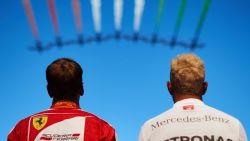 MONZA, ITALY - SEPTEMBER 06:  Lewis Hamilton of Great Britain (R) and Mercedes GP watches the Italian acrobatic patrol 'Frecce Tricolori' next to Sebastian Vettel of Germany and Ferrari before the Formula One Grand Prix of Italy at Autodromo di Monza on September 6, 2015 in Monza, Italy.  (Photo by Guido De Bortoli/Getty Images)