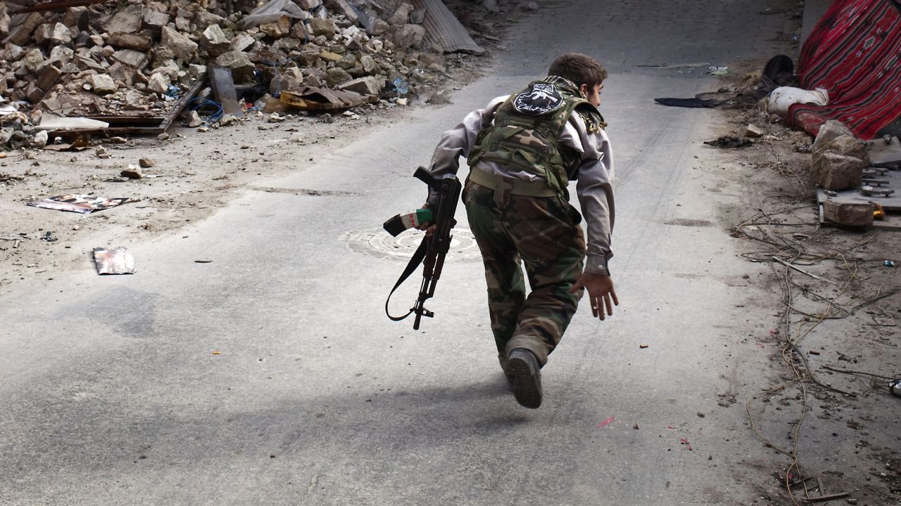 A Syrian rebel crosses a street while trying to dodge sniper fire in the old city of Aleppo in northern Syria on March 11, 2013. Syria warned on March 12 it is ready to fight "for years" against rebels, as world powers worked on a new initiative to find regime officials suitable for peace talks with the opposition. AFP PHOTO/JM LOPEZ        (Photo credit should read JM LOPEZ/AFP/Getty Images)