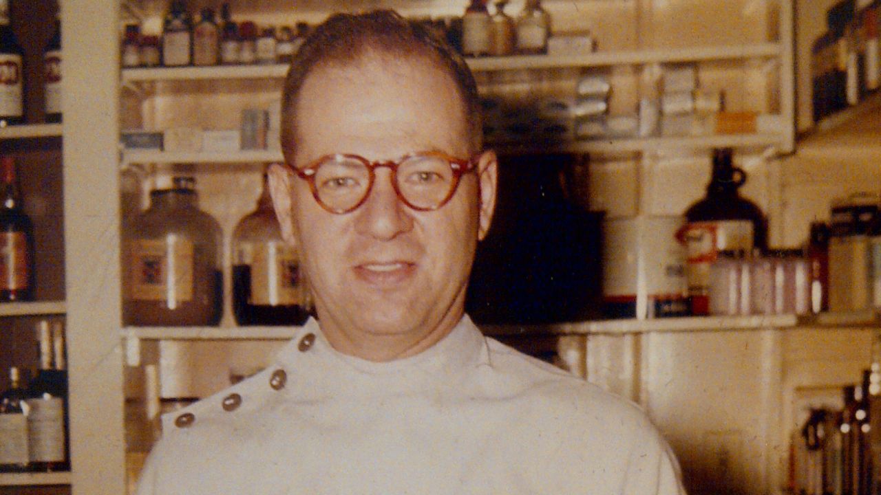 Sandy Halperin's father, Leon, standing in his pharmacy. Leon died of Alzheimer's in 1998.