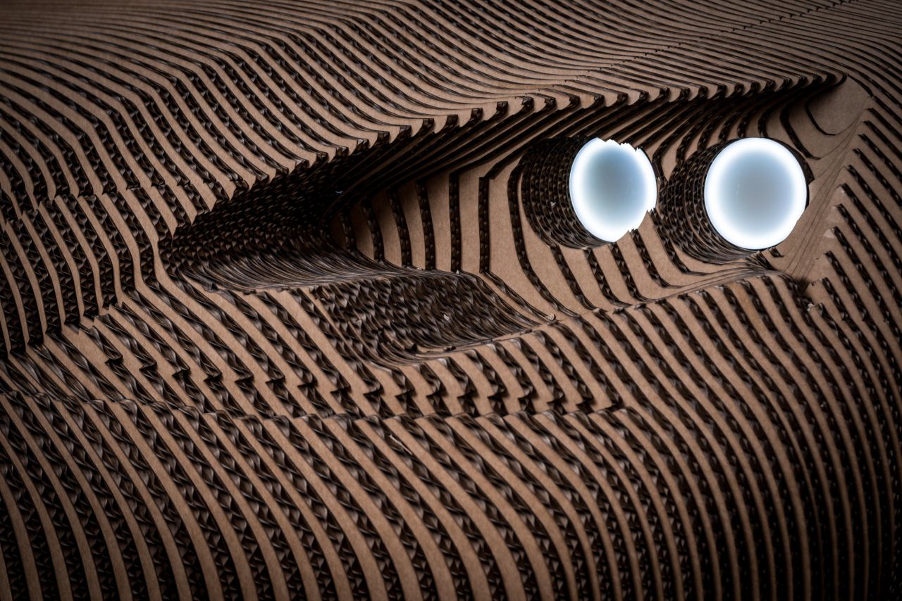 Made from 1,700 fully recyclable laser-cut cardboard sheets, the one-off replica has functioning lights.