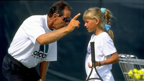 Coach Nick Bollettieri gives instructions to a young Anna Kournikova during training at his academy.