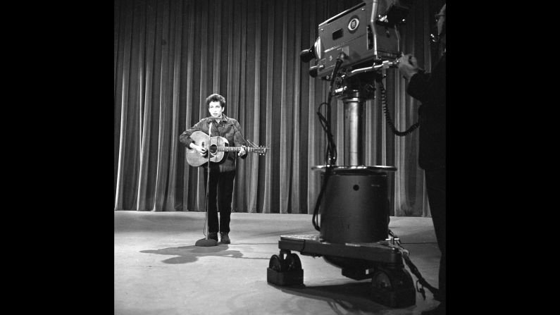 In 1963, Dylan got the call performers dreamed about: an appearance on "The Ed Sullivan Show," one of the most popular TV shows in the country. (A year later, <a href="index.php?page=&url=http%3A%2F%2Fwww.cnn.com%2F2014%2F01%2F30%2Fshowbiz%2Fcelebrity-news-gossip%2Fbeatles-ed-sullivan-50-years-anniversary%2F">Sullivan would introduce the Beatles.)</a> At rehearsals, shown here, Dylan performed "Talkin' John Birch Paranoid Blues." But some CBS brass, <a href="index.php?page=&url=http%3A%2F%2Fquery.nytimes.com%2Fmem%2Farchive-free%2Fpdf%3Fres%3D9A06E5D8133CE63ABC4C52DFB3668388679EDE" target="_blank" target="_blank">worried about controversy</a> over the song's mockery of the right-wing John Birch Society, were nervous, and <a href="index.php?page=&url=http%3A%2F%2Fwww.history.com%2Fthis-day-in-history%2Fbob-dylan-walks-out-on-the-ed-sullivan-show" target="_blank" target="_blank">Dylan declined to perform something else.</a> He never did appear on "Sullivan."