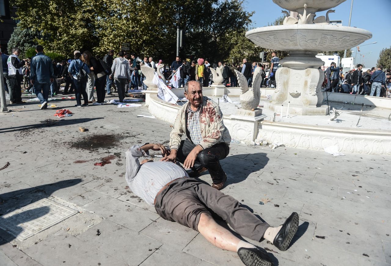 A wounded man lays on the ground at the site of an explosion in Ankara, Turkey, on Saturday, October 10. Two powerful bombs exploded near the main train station in Ankara on Saturday morning.