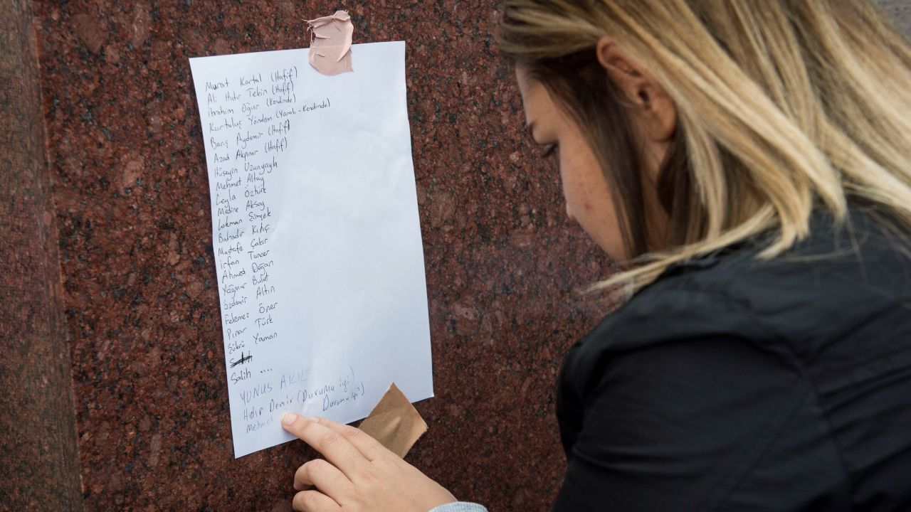 A woman looks at a list at the Ibn-i Sina hospital of people who were injured in the explosion.