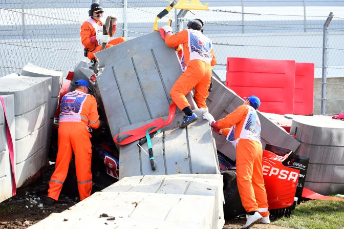 Marshalls remove barriers from the top of the Toro Rosso of Carlos Sainz Jr. after the Spaniard's high speed crash at the Russian Grand Prix.