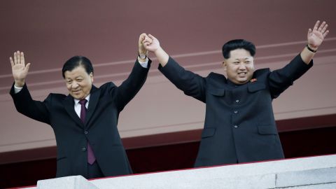 North Korean leader Kim Jong Un, right, stands with visiting Chinese official Liu Yunshan above the parade in Pyongyang.