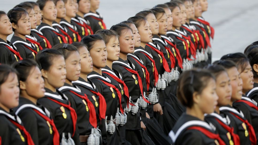 North Korean girls wear replica grenades as they march during the parade in Pyongyang.