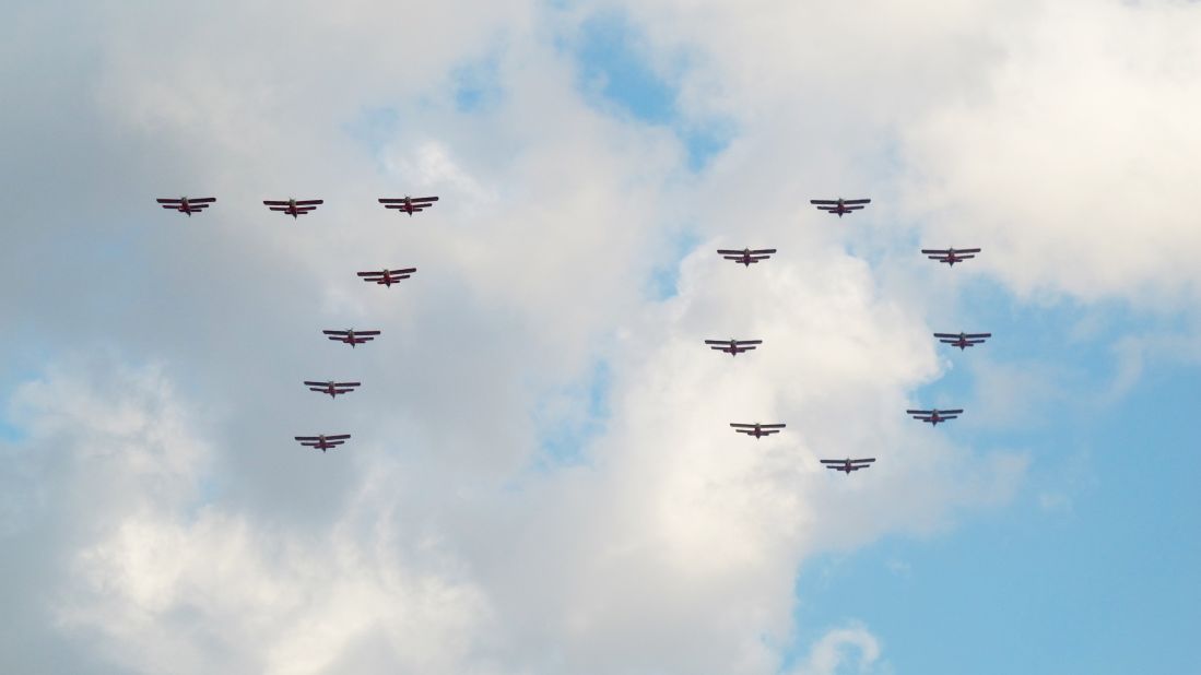 North Korean airplanes fly in formation over  Pyongyang's Kim Il Sung Square, displaying the number 70. 