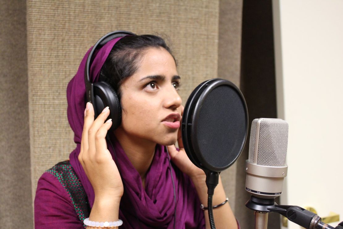 Sonita Alizadeh raps into a microphone at a music studio on her campus at Wasatch Academy.