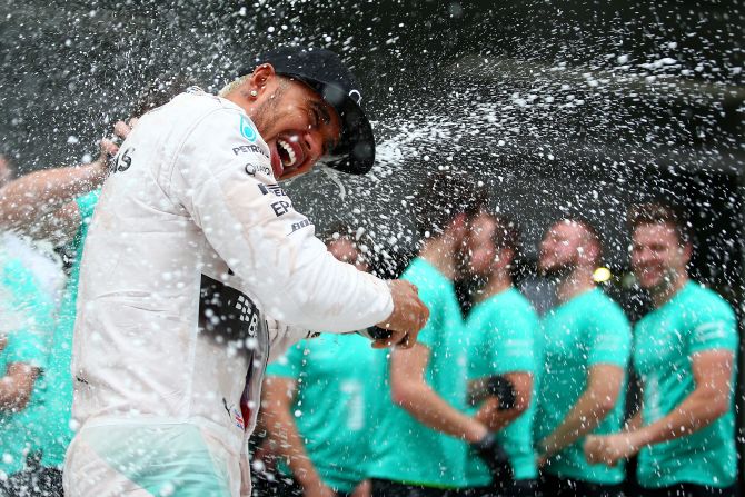 Hamilton was drenched in bubbly by his Mercedes team, which clinched its second successive constructors' title despite Nico Rosberg failing to finish the race. 