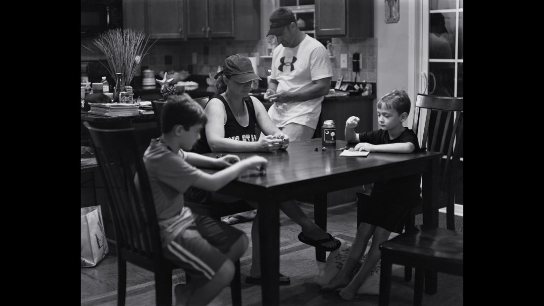 A family is gathered around the kitchen table but distracted from one another by invisible mobile devices. "I'm hoping there are going to be some families that see this work and they put a basket by the door and the phones go in it before they all sit down to dinner," Pickersgill said. 