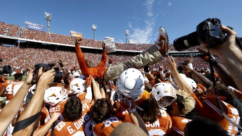 Texas football players carry head coach Charlie Strong after the Longhorns upset their rival Oklahoma on Saturday, October 10. Texas won 24-17 to hand Oklahoma its first loss of the season.