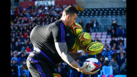 New Zealand rugby player Sonny Bill Williams tries to carry as many balls as he can during a community event in Darlington, England, on Thursday, October 8. The "All Blacks" are based in Darlington for the Rugby World Cup, which is now in the knockout stage. 