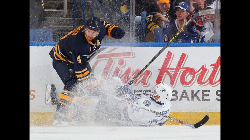 Tampa Bay's Erik Condra is upended by Buffalo's Josh Gorges during an NHL game in Buffalo, New York, on Saturday, October 10.