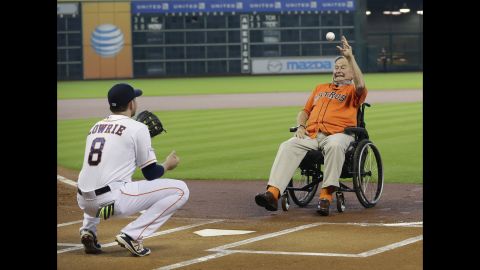 Former U.S. President George H.W. Bush throws out the ceremonial first pitch to Houston's Jed Lowrie before Game 3 of the American League Division Series on Sunday, October 11.
