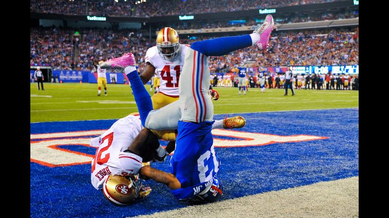 San Francisco defensive back Tramaine Brock pulls down an interception next to New York Giants wide receiver Odell Beckham Jr. during an NFL game in East Rutherford, New Jersey, on Sunday, October 11.