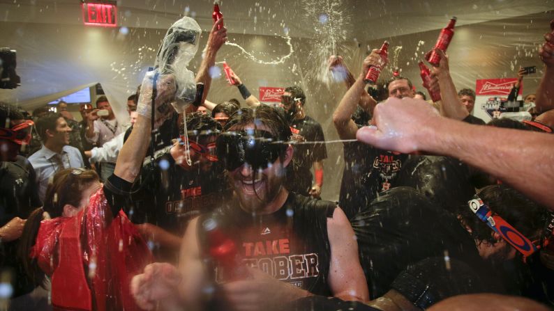 The Houston Astros celebrate in their locker room after they defeated the New York Yankees in the American League wild card game on Tuesday, October 6.