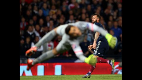 Polish goalkeeper Lukasz Fabianski can't stop a shot from Scotland's Steven Fletcher during a Euro 2016 qualifier in Glasgow, Scotland, on Thursday, October 8. The match ended in a 2-2 draw.