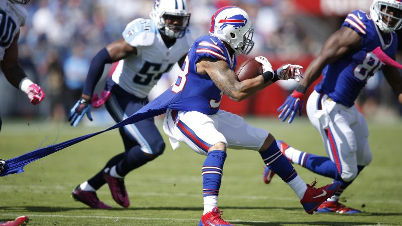 Buffalo running back Dan Herron has his jersey ripped as he runs during an NFL game in Nashville, Tennessee, on Sunday, October 11.