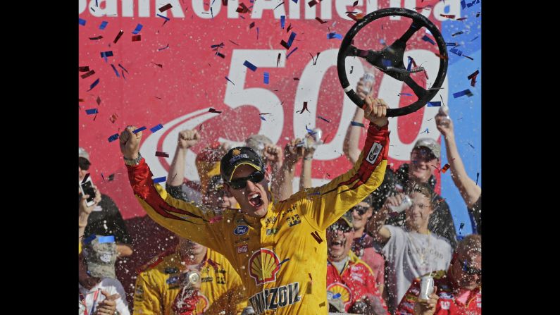 NASCAR driver Joey Logano celebrates in Victory Lane after winning the Sprint Cup race at Charlotte Motor Speedway on Sunday, October 11. Logano earned a spot in the third round of NASCAR's Chase for the Sprint Cup.