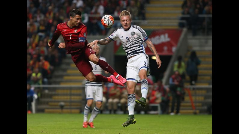 Portugal's Cristiano Ronaldo, left, battles Denmark's Simon Kjaer for a header during a Euro 2016 qualifier in Braga, Portugal, on Thursday, October 8. Portugal won 1-0 to punch its ticket to next year's tournament.