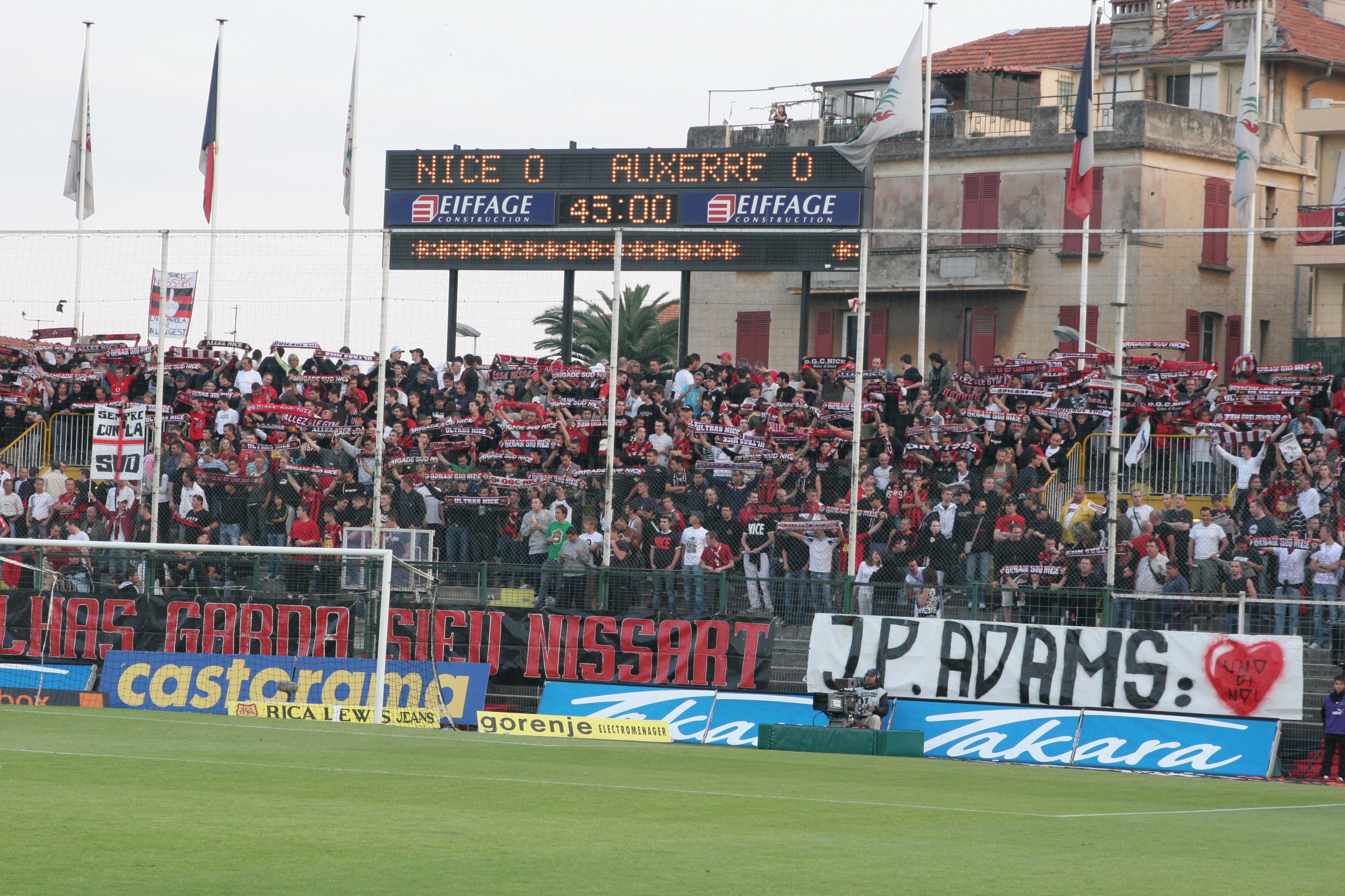 Nice fans display a banner reading "J-P Adams: One of Us" on April 28, 2007, ahead of their former player's sons -- Laurent and Frédéric -- symbolically kicking off a match against Auxerre in tribute to their father.