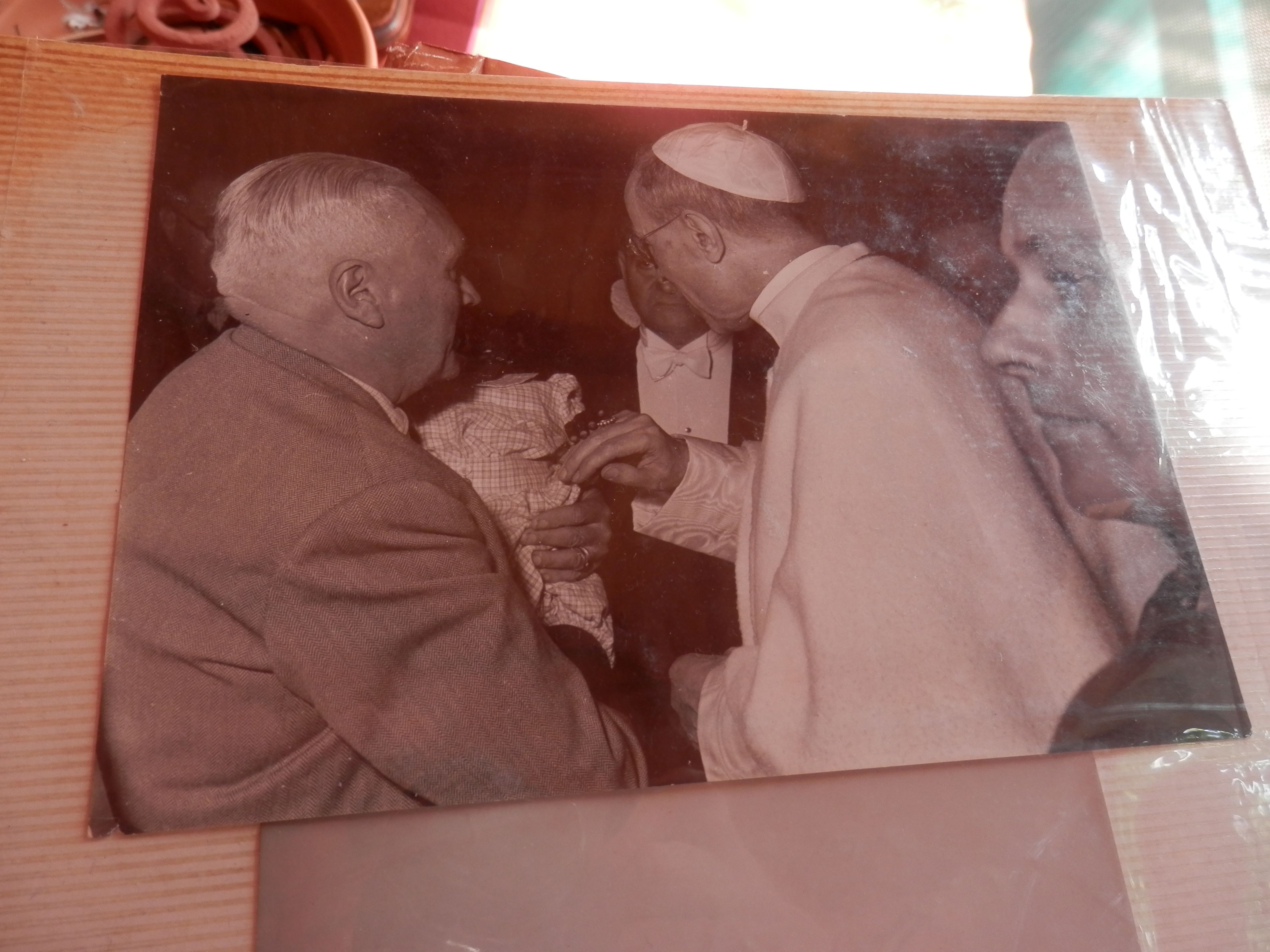 Hidden in the darkness, Jean-Pierre meets Pope Pius XII shortly after being taken to Europe by his grandmother from Senegal. The picture is from a scrapbook that Bernadette still holds.