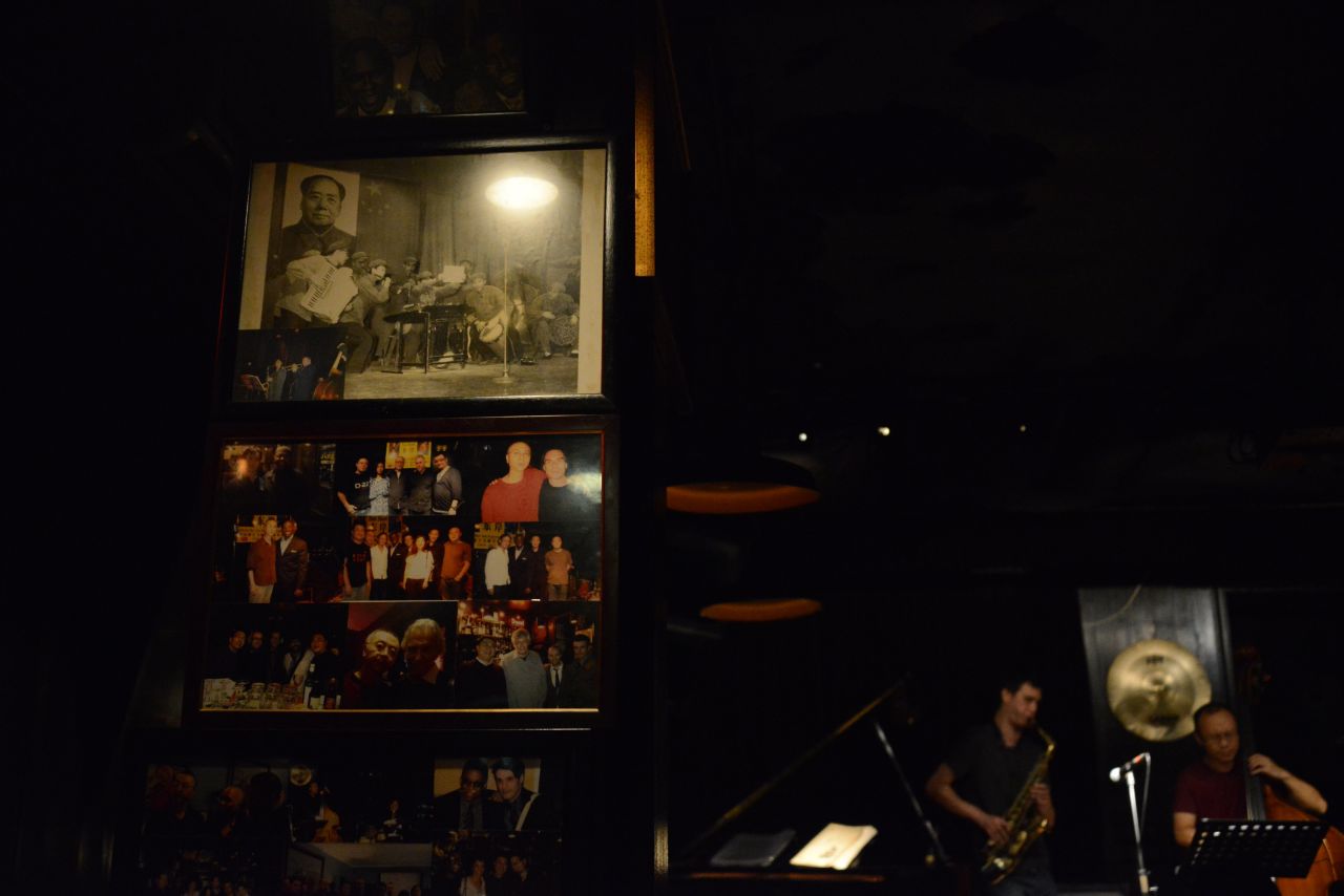 Posters of Miles Davis and Billie Holiday adorn the East Shore Live Jazz Cafe, along with a picture of a Chinese orchestra from the Cultural Revolution era.